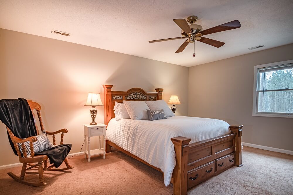 a bedroom with a big ceiling fan 