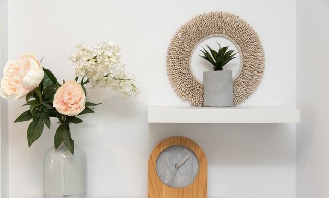 Ways To Create More Storage Space In Your Home DECORATION DISPLAYED ON WHITE SHELVES.