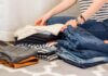Health Benefits Of A Decluttered Home A woman folding clothes