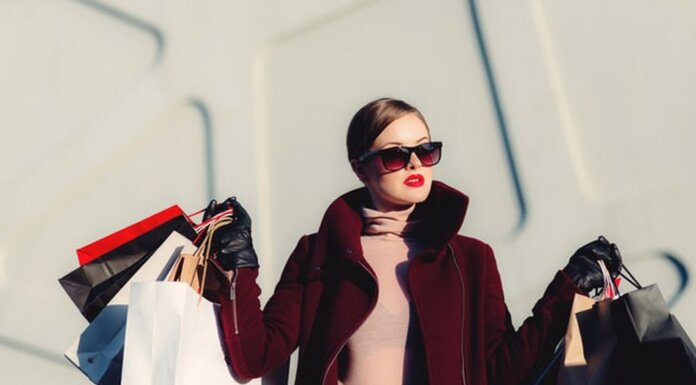 Fashion Trends That Are Making A Comeback In 2021 A woman returning from shopping holding several bags.