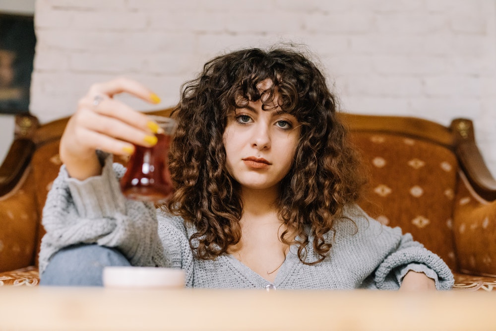 A woman with curly hair and bangs