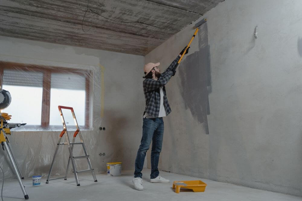 A man painting a wall.